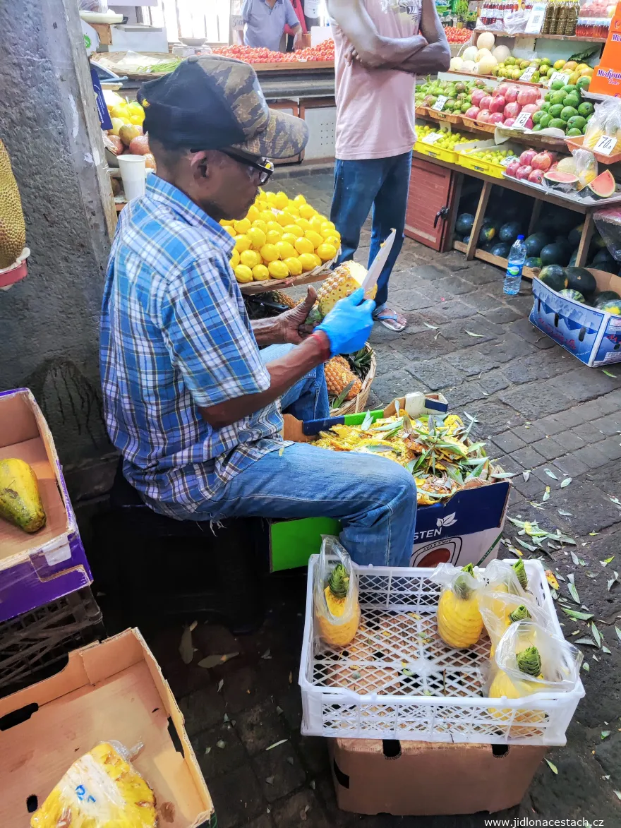 Cleaning pineapple at the market in Port Louis Cleaning pineapple at the market in Port Louis