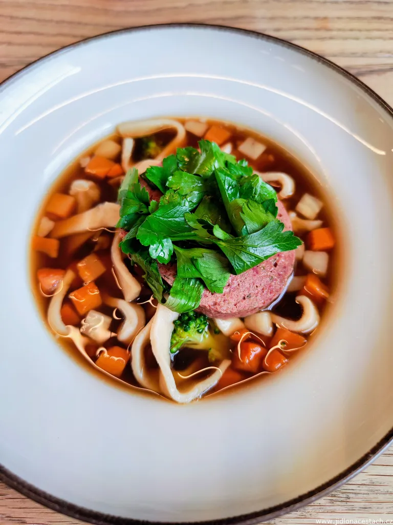 Beef broth with noodles, vegetables and one large liver dumpling