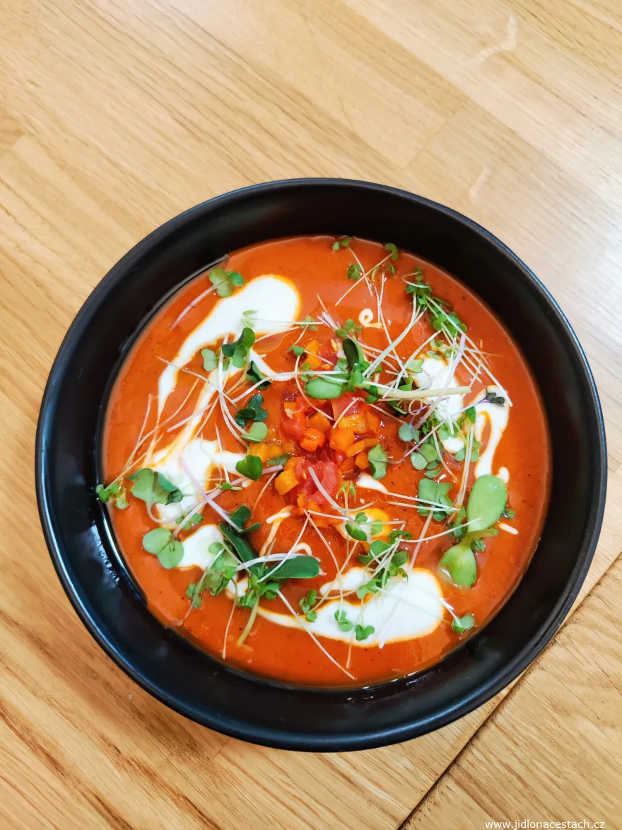 Kamin Restaurant: cold bell pepper soup with cream, padrón peppers, and herbs.