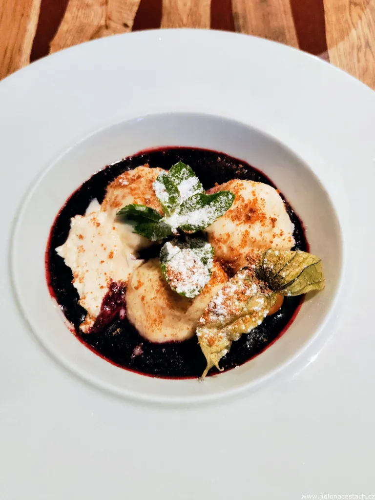 Curd dumplings filled with nougat and blueberry sauce