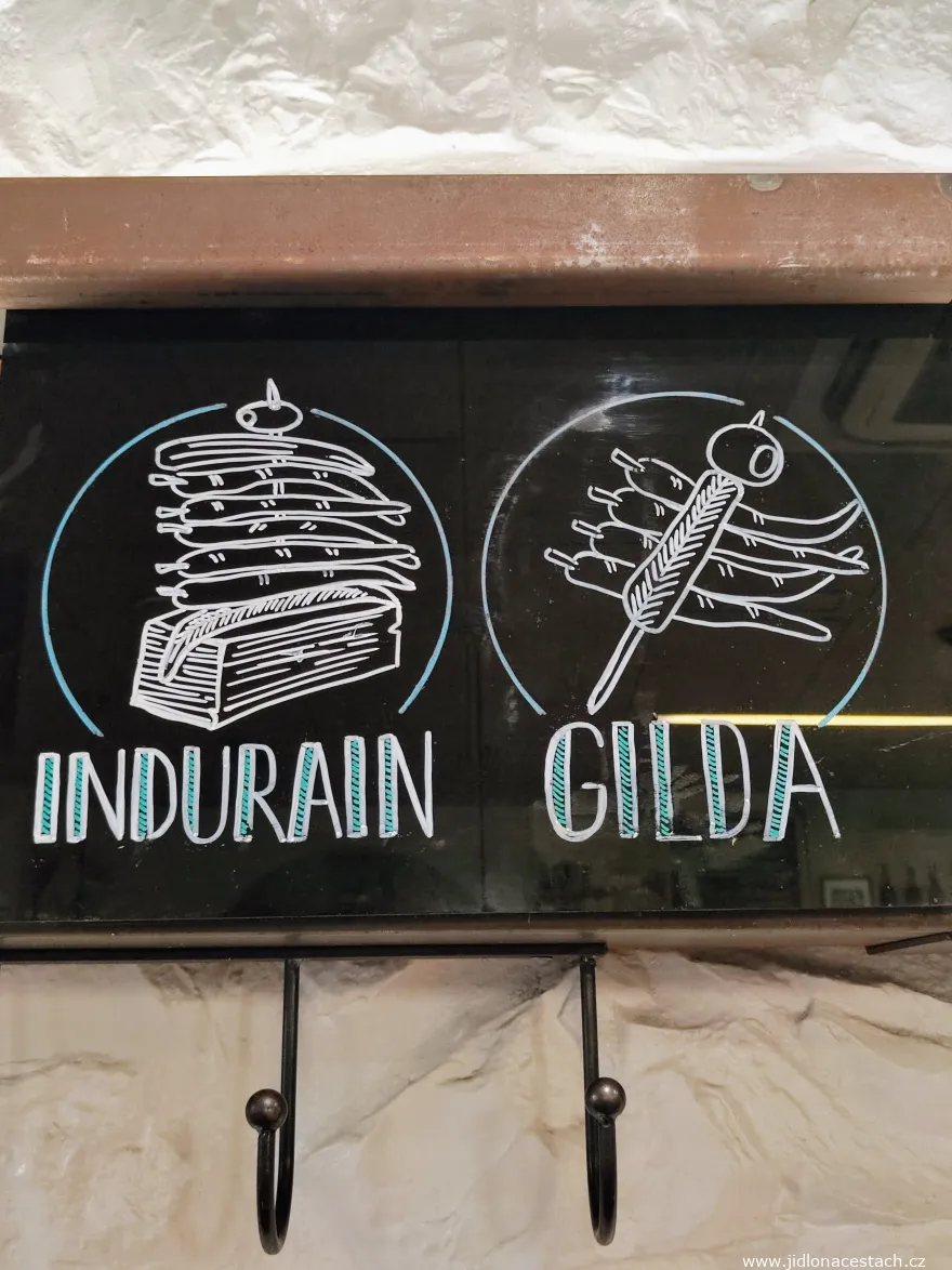 Depiction of two pintxos with their own names on a restaurant board in San Sebastián: pintxo Gilda and pintxo Indurain. Depiction of two pintxos with their own names on a restaurant board in San Sebastián: pintxo Gilda and pintxo Indurain.