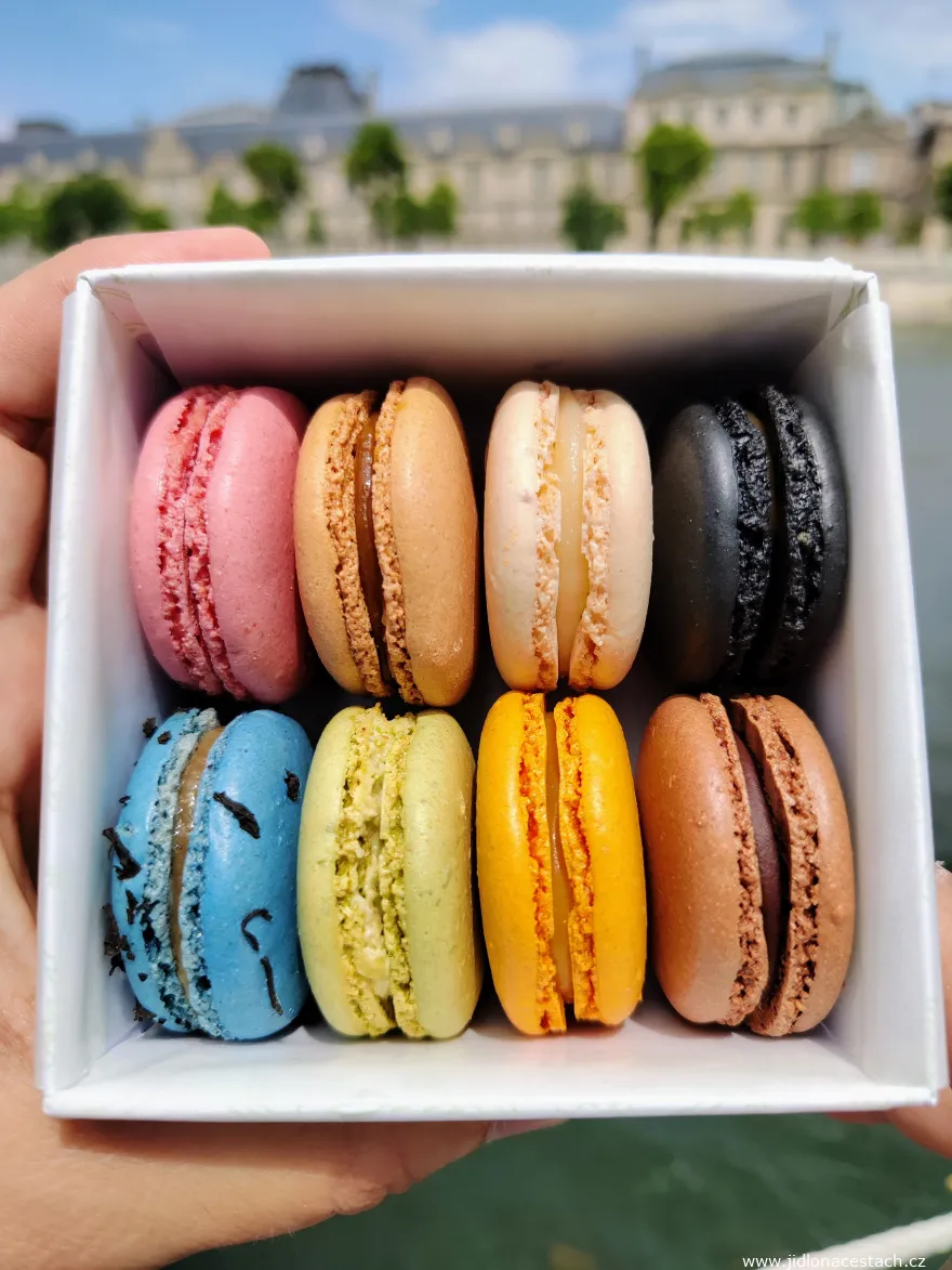 Macarons, dessert typiquement français. Ceux-ci viennent de la célèbre pâtisserie parisienne Ladurée. En arrière-plan, le Louvre et la Seine. Macarons, dessert typiquement français. Ceux-ci viennent de la célèbre pâtisserie parisienne Ladurée. En arrière-plan, le Louvre et la Seine.