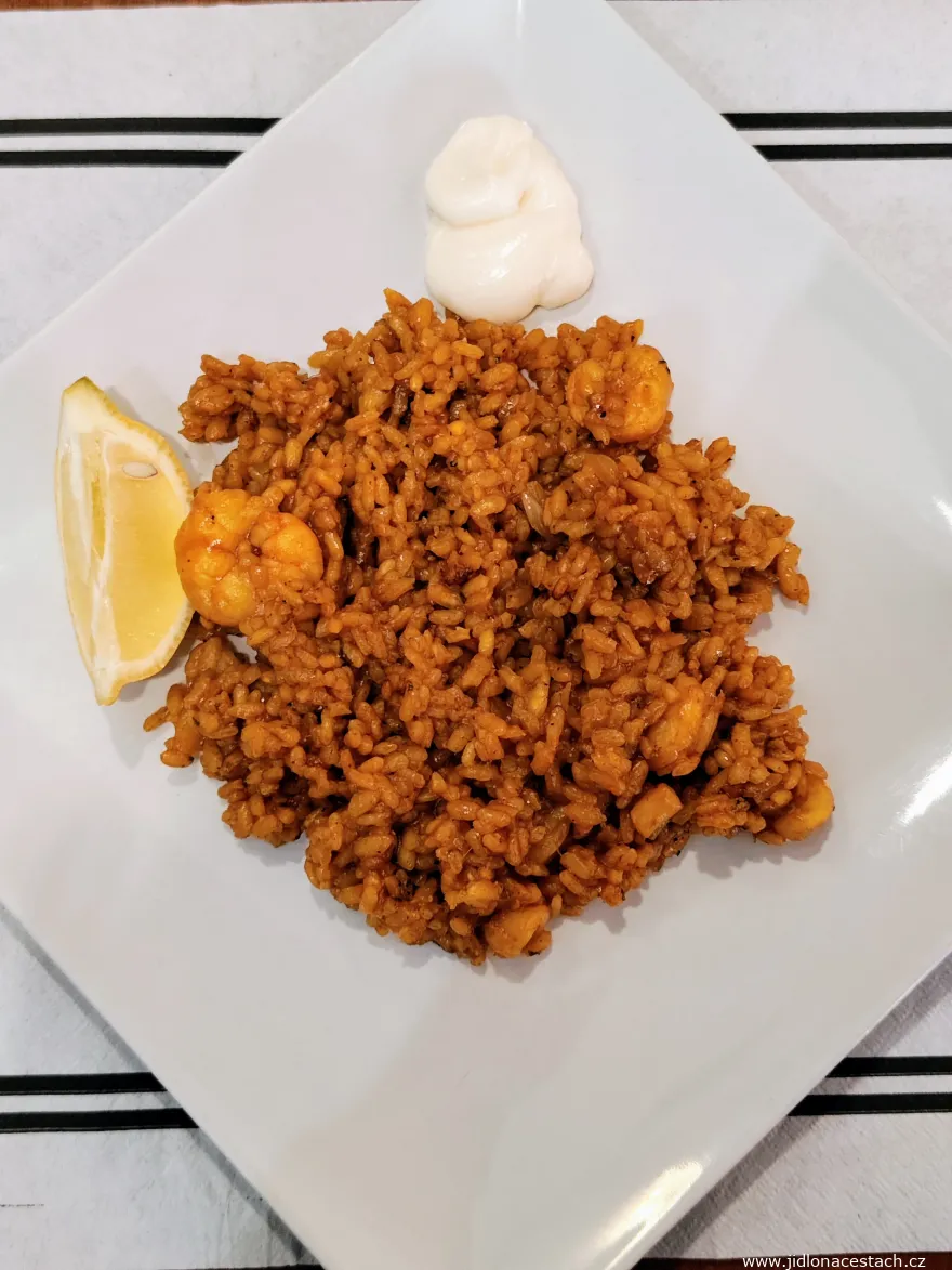 Arròs a banda, a dish typical of the Alicante area. Rice with seafood, garlic aioli, and a slice of lemon. This particular plate is from a Spanish lunch menu (menú del día), and it had a perfectly crispy socarrat (the crunchy rice formed at the bottom of the pan). Arròs a banda, a dish typical of the Alicante area. Rice with seafood, garlic aioli, and a slice of lemon. This particular plate is from a Spanish lunch menu (menú del día), and it had a perfectly crispy socarrat (the crunchy rice formed at the bottom of the pan).