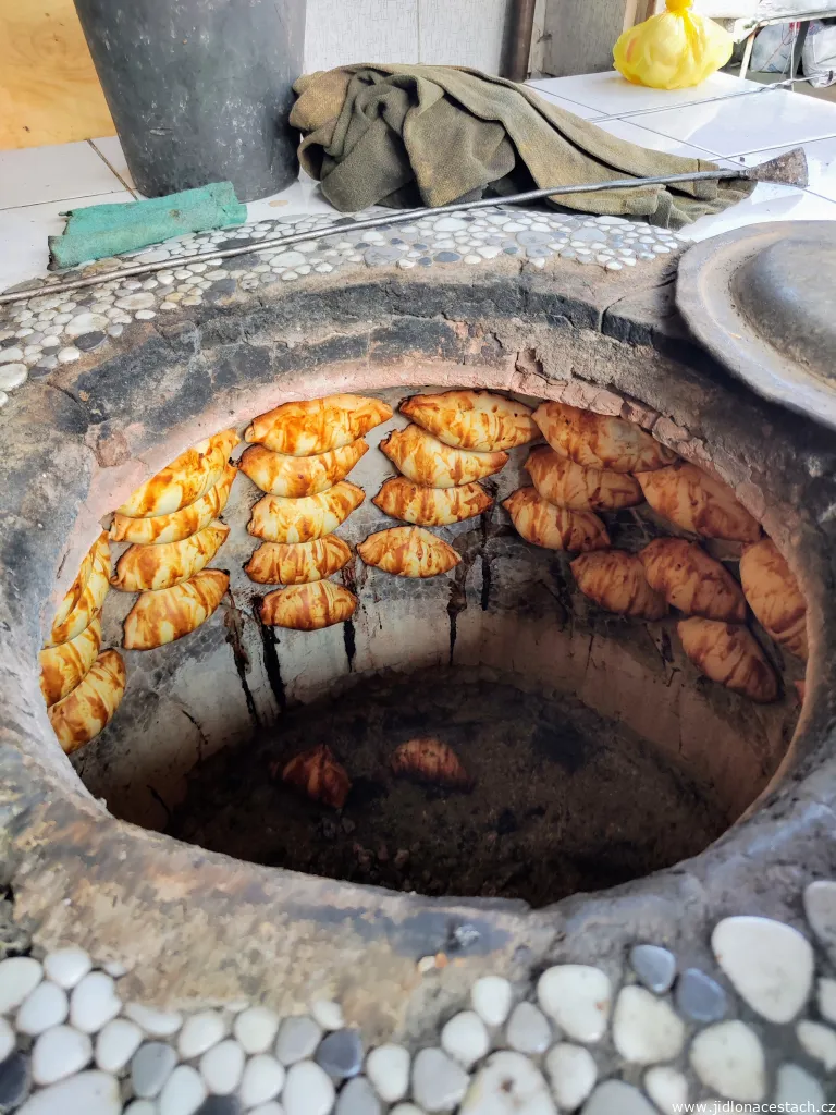 Baking samsa in a traditional tandyr oven. Baking samsa in a traditional tandyr oven.