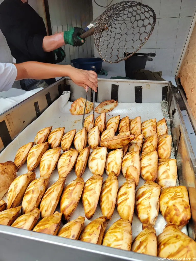 Removing samsa from the tandyr oven and preparing it for sale. Removing samsa from the tandyr oven and preparing it for sale.