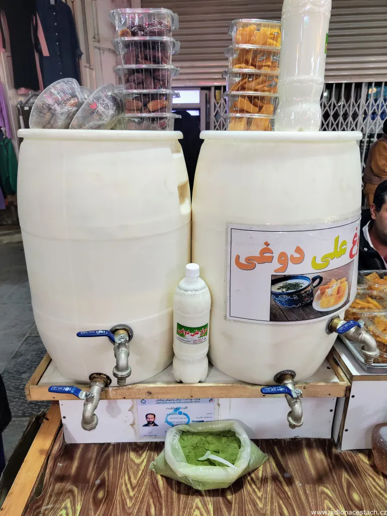 Doogh sold at a market in Esfahan. Dried mint can be added to taste. Note the two taps, each set at a different height on the barrel.