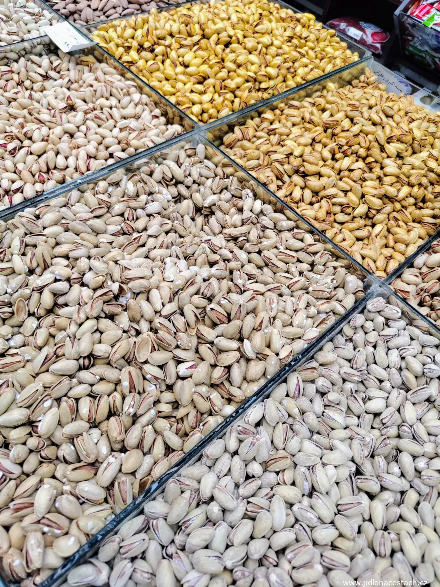 Akhbari pistachios at a specialized seller in Iran. Separate boxes contain saffron pistachios, lightly salted, salted, and pistachios roasted with lemon juice. Akhbari pistachios at a specialized seller in Iran. Separate boxes contain saffron pistachios, lightly salted, salted, and pistachios roasted with lemon juice.