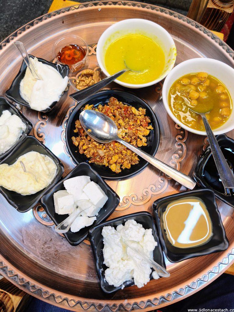Typical Iraqi breakfast: makhlama, several types of cheese, thick cream, tahini, nuts, honey, date syrup, and soups.